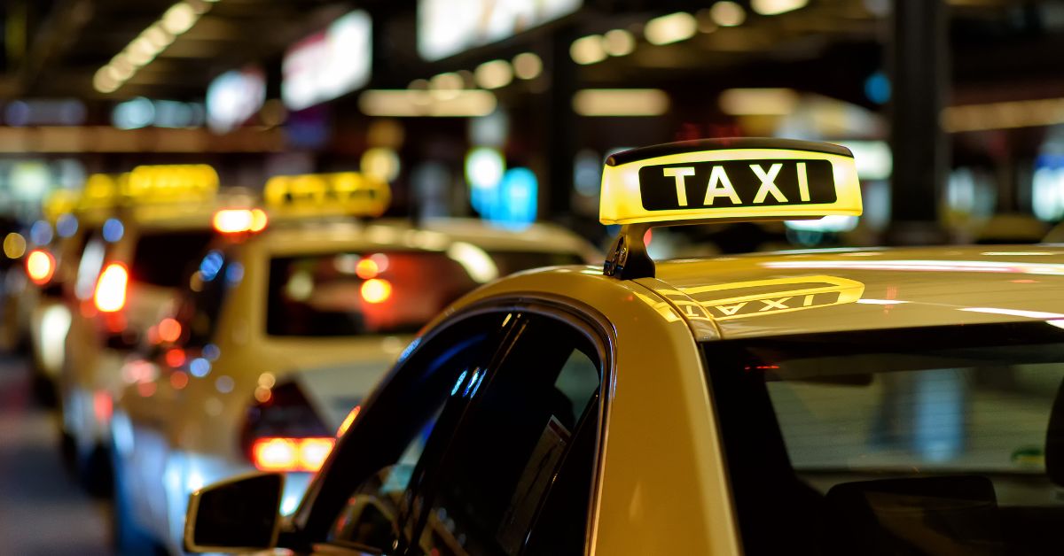 a picture of multiple taxis moving on a road